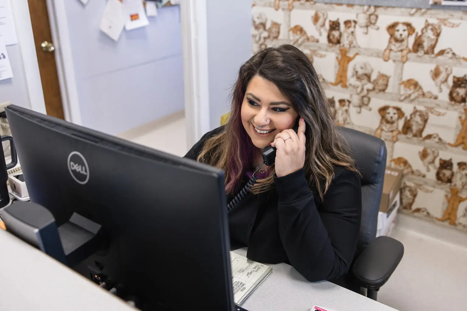 Front desk staff member assisting clients by phone at Walkersville Veterinary Clinic.
